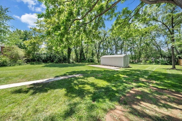 view of green lawn with an outbuilding and a shed