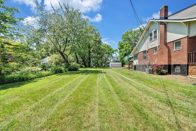 view of green lawn featuring central air condition unit