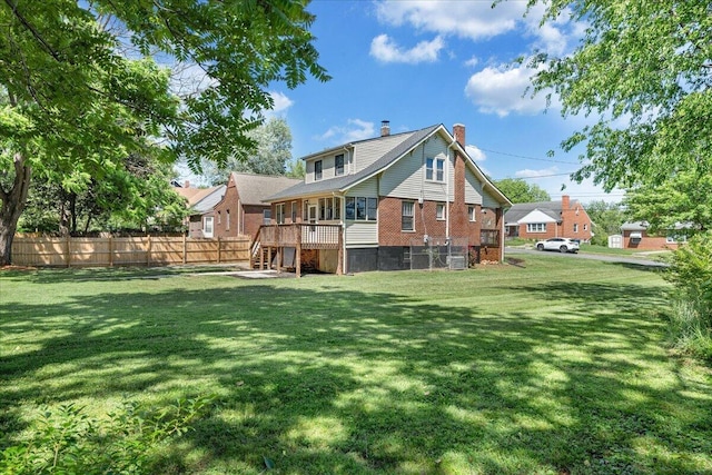rear view of house featuring a chimney and brick siding