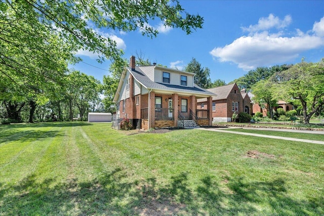 view of front facade featuring brick siding, a chimney, a front lawn, and a porch