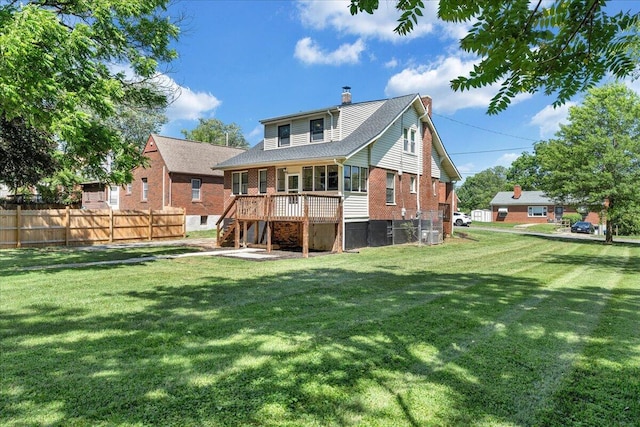 back of property with a chimney, stairs, brick siding, and a deck