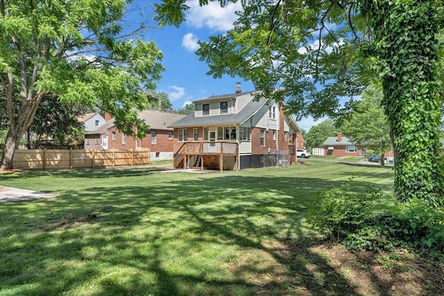 rear view of property featuring a chimney and brick siding