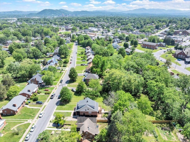 aerial view of property and surrounding area featuring mountains and nearby suburban area