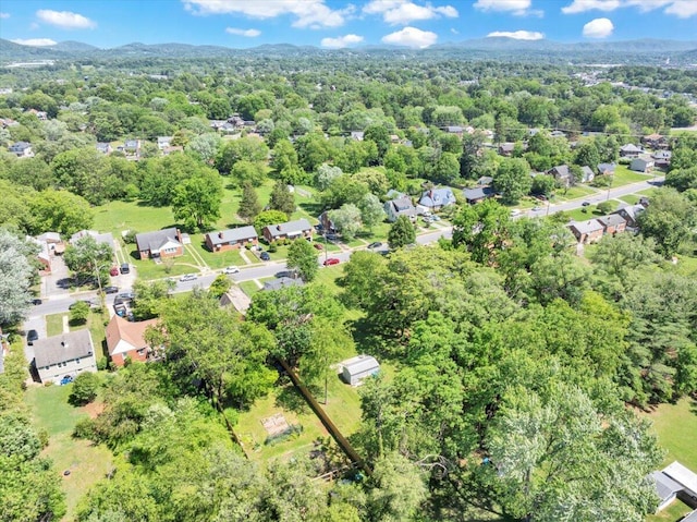 aerial view of property and surrounding area with nearby suburban area and a forest