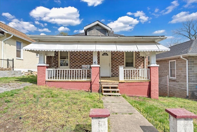 4 14th St SW, Roanoke, VA 24016 - bungalow-style home featuring fence, covered porch, and brick siding