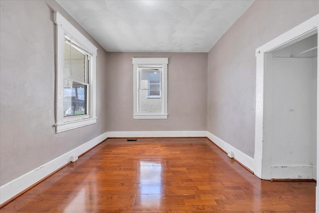 4 14th St SW, Roanoke, VA 24016 - unfurnished room with baseboards, visible vents, and wood finished floors