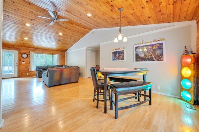 dining room featuring vaulted ceiling, wood finished floors, wood ceiling, and ceiling fan