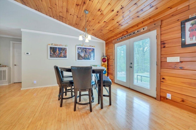 dining area with lofted ceiling, light wood finished floors, wooden ceiling, french doors, and baseboards
