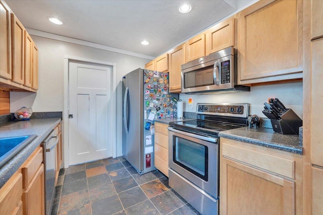 kitchen with recessed lighting, stainless steel appliances, dark countertops, light brown cabinets, and stone finish flooring
