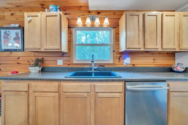 kitchen featuring dishwasher, dark countertops, light brown cabinetry, and a sink