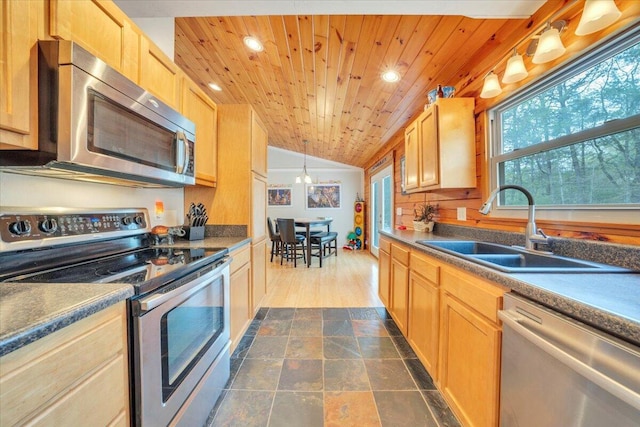 kitchen featuring vaulted ceiling, a sink, wooden ceiling, appliances with stainless steel finishes, and recessed lighting