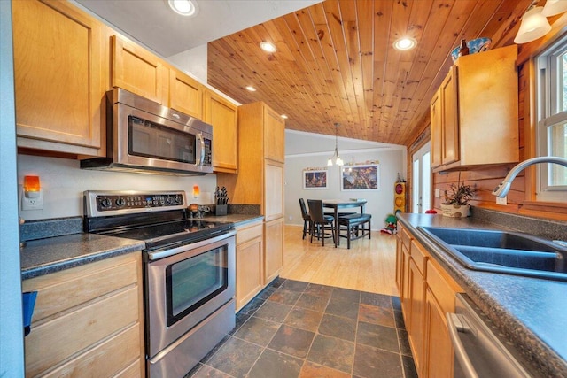 kitchen featuring wooden ceiling, a sink, vaulted ceiling, and appliances with stainless steel finishes