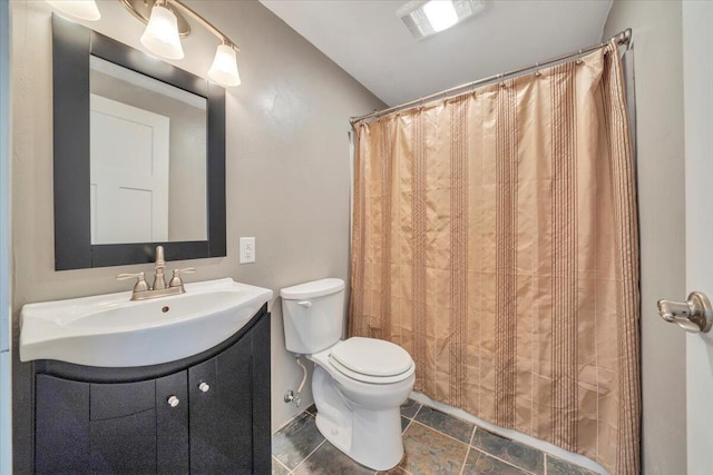full bath with toilet, vanity, and vaulted ceiling