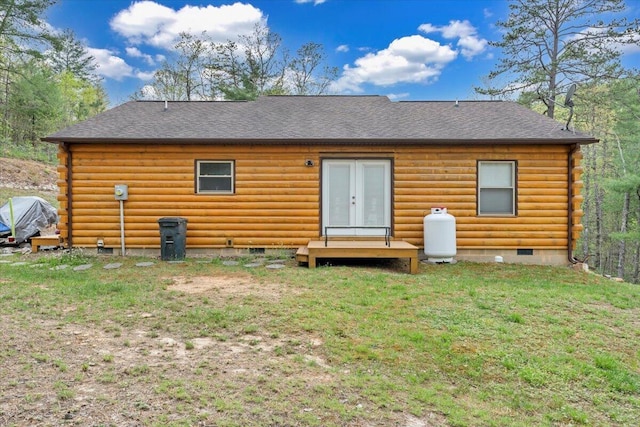 back of property with crawl space, a shingled roof, and log siding