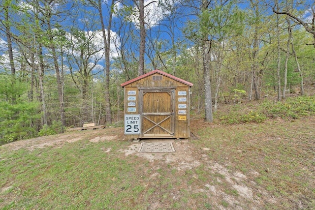 view of shed featuring a forest view