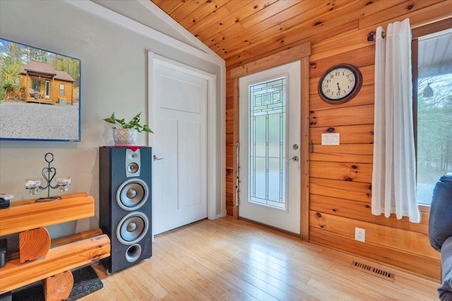 entrance foyer featuring lofted ceiling, plenty of natural light, visible vents, and hardwood / wood-style floors