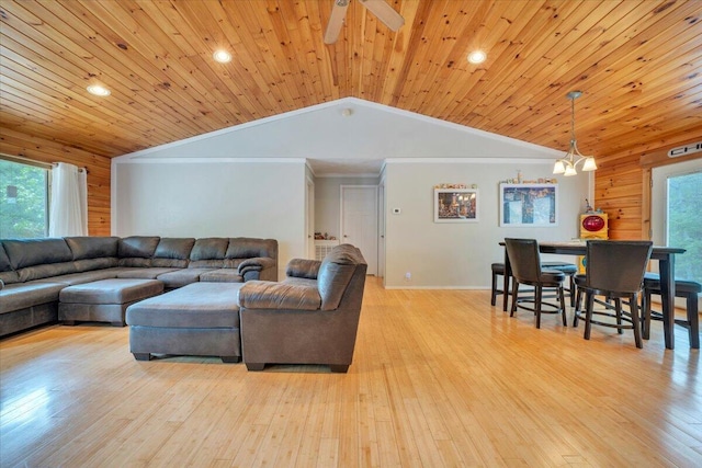 living room with lofted ceiling, a ceiling fan, and light wood-style flooring