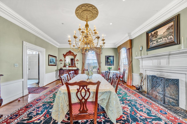 420 S Church St, Fincastle, VA 24090 - dining space with wood finished floors, a chandelier, crown molding, a wainscoted wall, and a fireplace