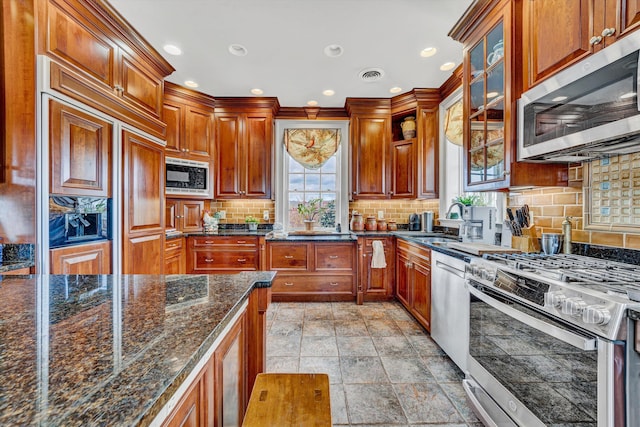 420 S Church St, Fincastle, VA 24090 - kitchen featuring built in appliances, a sink, tasteful backsplash, recessed lighting, and glass insert cabinets