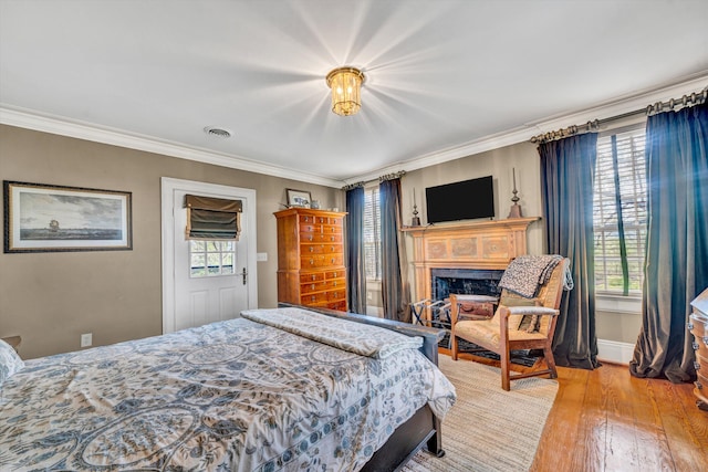 420 S Church St, Fincastle, VA 24090 - bedroom with multiple windows, crown molding, wood finished floors, a fireplace, and baseboards