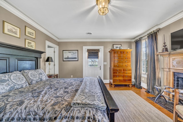 420 S Church St, Fincastle, VA 24090 - bedroom with multiple windows, wood finished floors, crown molding, a fireplace with flush hearth, and baseboards