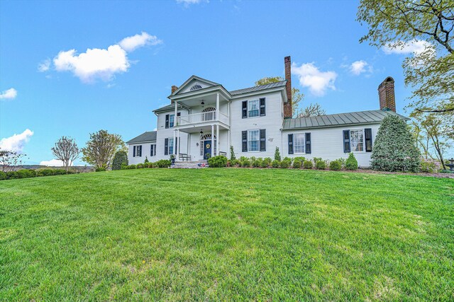 420 S Church St, Fincastle, VA 24090 - neoclassical / greek revival house with a chimney, a balcony, a front yard, and a standing seam roof
