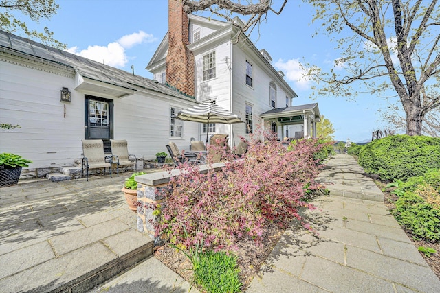 420 S Church St, Fincastle, VA 24090 - view of home's exterior featuring a chimney and a patio area