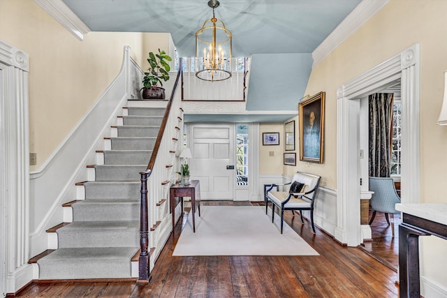 420 S Church St, Fincastle, VA 24090 - foyer entrance featuring hardwood / wood-style flooring, stairs, a chandelier, crown molding, and wainscoting