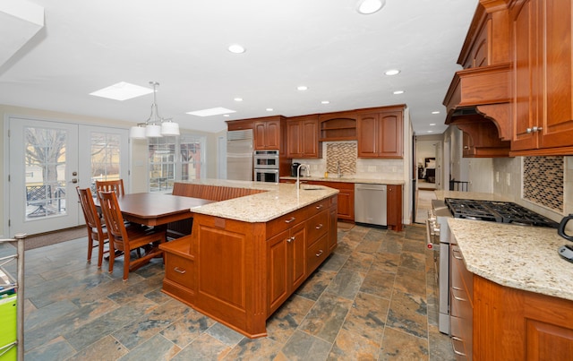 2902 Brughs Mill Rd, Fincastle, VA 24090 - kitchen with decorative backsplash, open shelves, high end appliances, a center island with sink, and a skylight