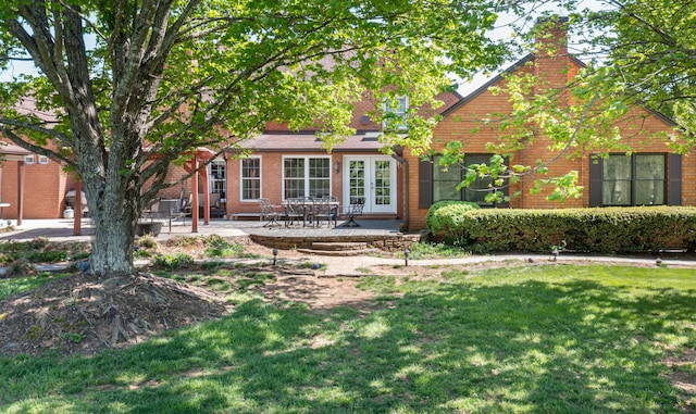 2902 Brughs Mill Rd, Fincastle, VA 24090 - rear view of house featuring a lawn, a chimney, a patio area, and brick siding