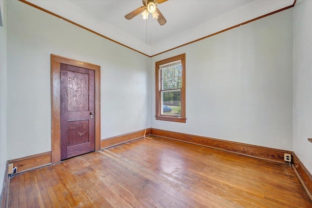 empty room with wood-type flooring, baseboards, and ceiling fan