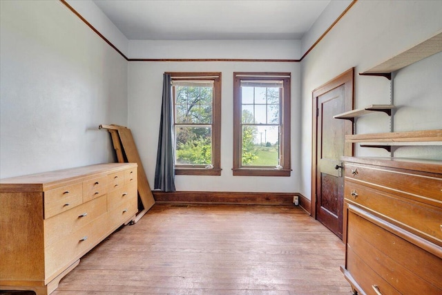 interior space with light wood-style floors and baseboards