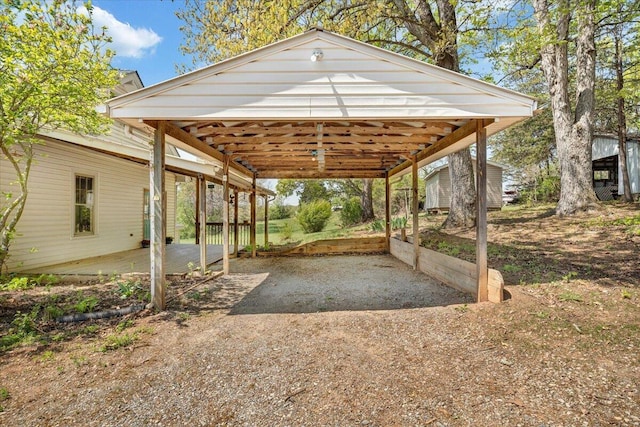 exterior space with a carport and dirt driveway