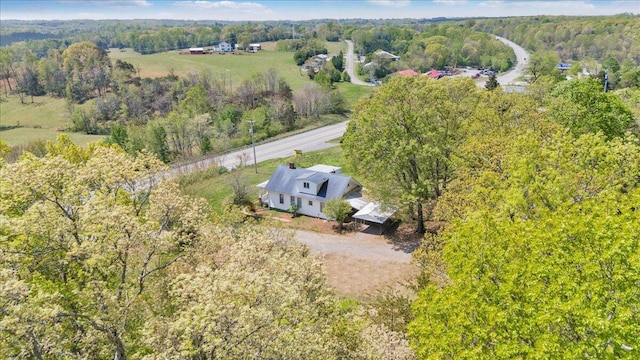 birds eye view of property featuring a rural view and a view of trees