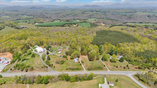 birds eye view of property with a forest view and a mountain view