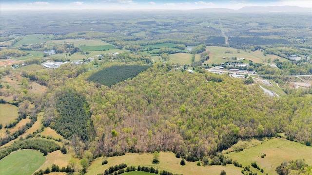 birds eye view of property featuring a view of trees