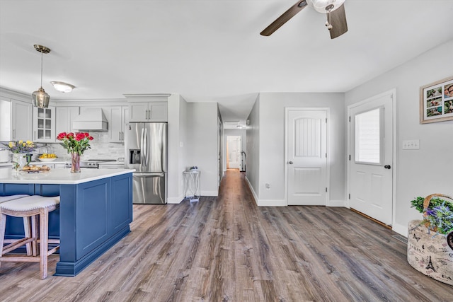 1410 Flowing Springs Rd, Buchanan, VA 24066 - kitchen featuring ceiling fan, a kitchen breakfast bar, light countertops, premium range hood, and stainless steel fridge
