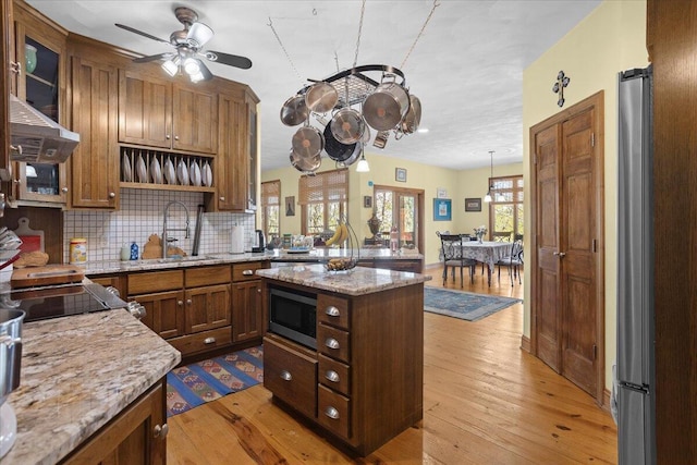 30 Boulder Point Dr, Hardy, VA 24101 - kitchen with a sink, light wood-style floors, decorative backsplash, ceiling fan, and light stone counters