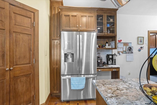 30 Boulder Point Dr, Hardy, VA 24101 - kitchen with stainless steel refrigerator with ice dispenser, tasteful backsplash, light stone countertops, brown cabinets, and glass insert cabinets