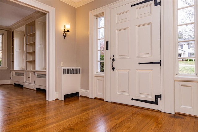 2912 Wycliffe Ave SW, Roanoke, VA 24014 - entrance foyer featuring radiator, wood finished floors, crown molding, and plenty of natural light