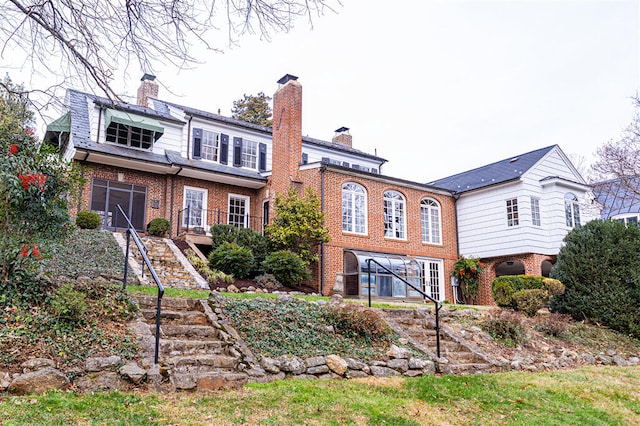2912 Wycliffe Ave SW, Roanoke, VA 24014 - rear view of house with a chimney, brick siding, stairs, and a garage