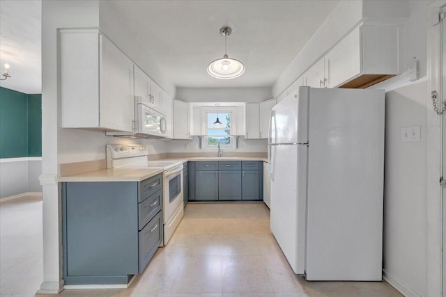 kitchen with pendant lighting, white cabinets, a sink, light countertops, and white appliances