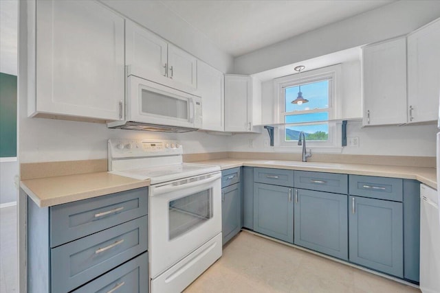 kitchen with light countertops, a sink, white cabinetry, and white appliances