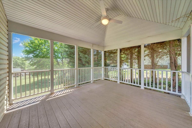 unfurnished sunroom with a ceiling fan