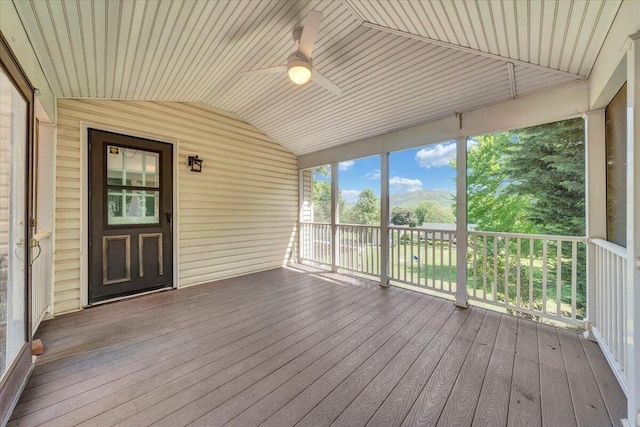 unfurnished sunroom featuring a ceiling fan