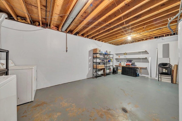 unfinished below grade area featuring washing machine and clothes dryer