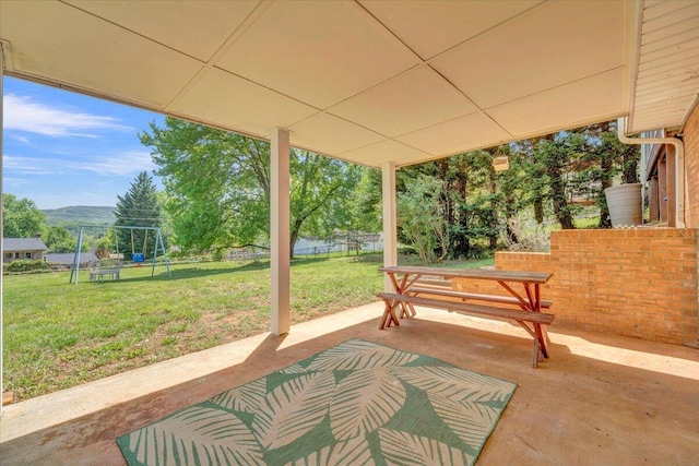 view of patio with a mountain view and fence