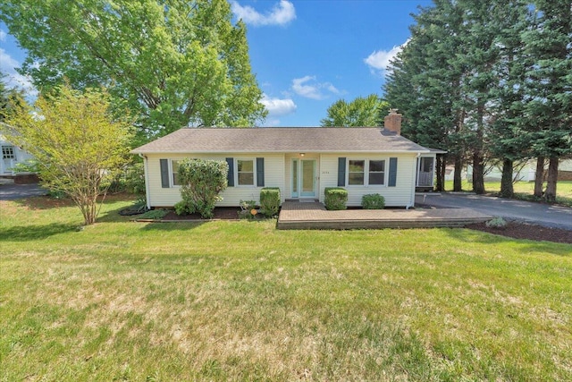 single story home with a front lawn and a chimney