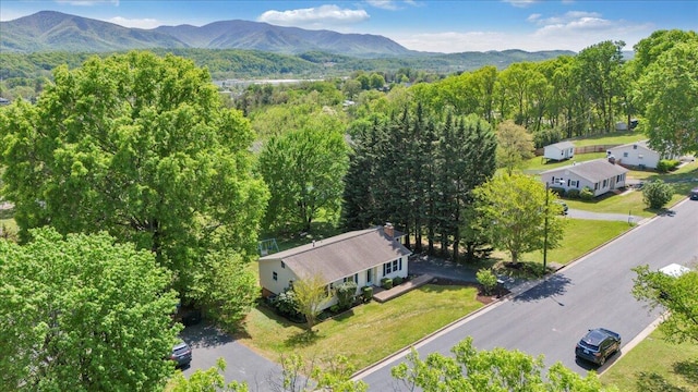 aerial view with a wooded view and a mountain view