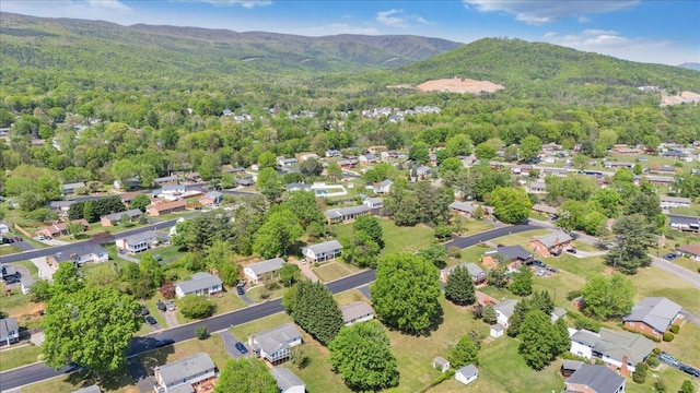 aerial view with a mountain view, a residential view, and a view of trees